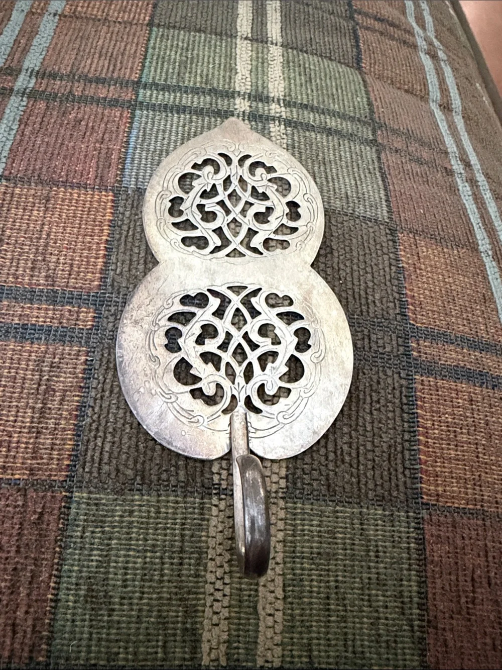 Pierced double lobed piece with hanging loop